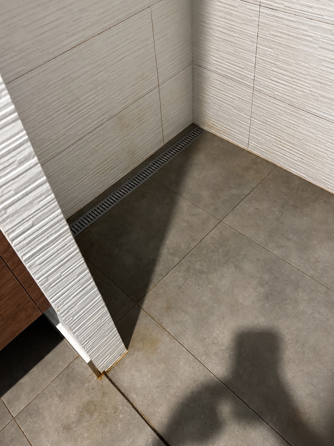 Marked shower floor before Lumi Cleaning